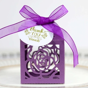 Close-up of purple laser-cut rose gift box with silk ribbon and thank you tag