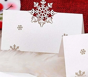 Elegant pearl white laser cut snowflake place cards for Christmas table settings