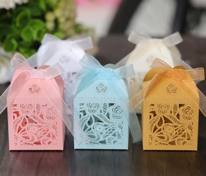 Detailed laser-cut rose hollow candy boxes with ribbons in multiple pastel colors
