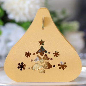 Golden Christmas tree cutout candy box with snowflake patterns and Ferrero chocolate