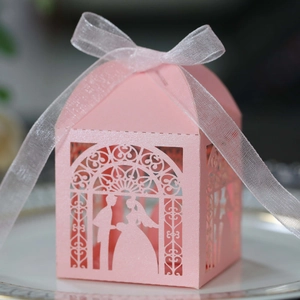 Pink laser-cut wedding candy box with bride and groom silhouette and organza ribbon