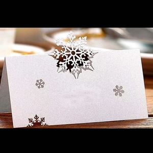 Elegant white laser-cut snowflake place card for winter wedding or Christmas table settings