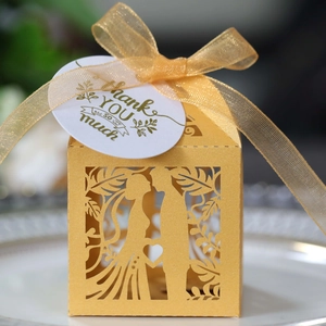 Laser cut gold favor box with groom and bride silhouette and elegant ribbon