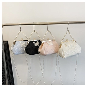 Detail of vintage frame bags with lace butterfly appliques and pearl handles in four colors