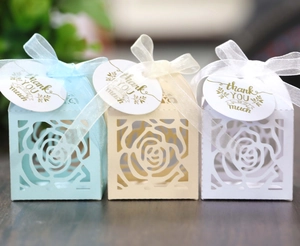 Detailed laser-cut hollow rose wedding favor boxes with thank you tags and ribbons