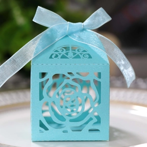 Detailed view of light blue laser-cut rose candy box with an elegant matching silk ribbon bow