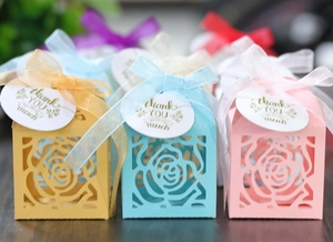 Detail of laser-cut hollow rose gift boxes with ribbons and thank you hang tags