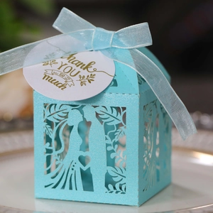 Detailed laser-cut wedding favor box in sky blue with ribbon and gold Thank You tag