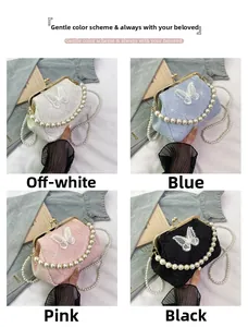 Detail of elegant handbag with pearl handles and lace butterfly in four classic colors