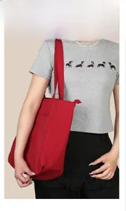 Vista modella della borsa shopper rossa capiente in nylon per pendolari quotidiani