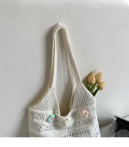 Close-up of hollowed-out crochet beach bag with colorful 3D floral knitting details