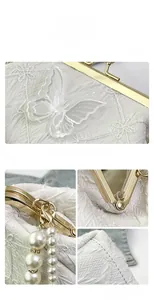 Detail showing the white fabric texture, butterfly lace embroidery and pearl pendants