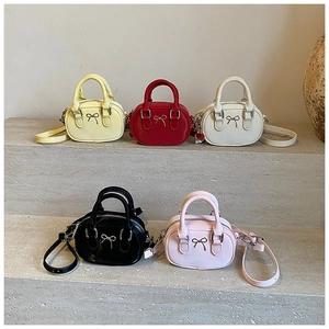 Detailed group view of mini bowling bags with bow accents in five various colors