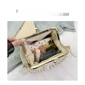 Top view of white lace clutch with pearl handle showing interior capacity for essentials