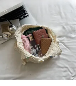 Detail view of white crochet tote bag interior showing large capacity and daisy decor