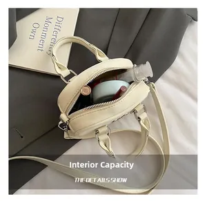 Internal view of mini off-white bowling bag showing capacity for cosmetics and lipstick
