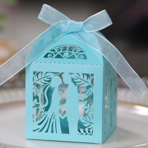 Detailed laser-cut light blue hollow candy box with romantic wedding silhouettes