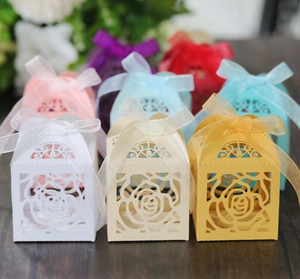 Detailed laser-cut hollow rose patterns on multicolored square wedding favor gift boxes