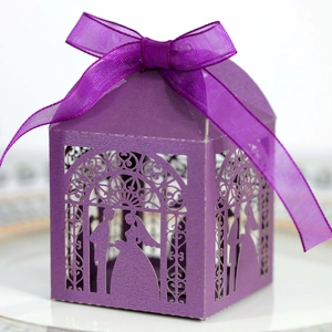 Detail of laser-cut purple wedding candy box featuring bride and groom silhouette