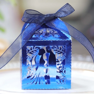 Macro shot of electro-blue wedding favor box with laser-cut bride and groom silhouette