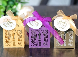 Detailed laser-cut wedding favor boxes with groom bride silhouette and ribbon bow