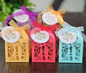 Close-up of laser-cut heart candy boxes with silk ribbons and Thank You tags