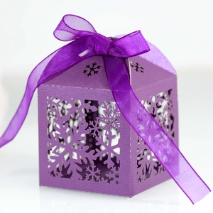 Detailed view of purple laser-cut snowflake candy gift box with elegant organza ribbon bow