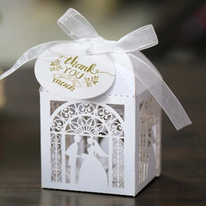 Elegant white laser-cut wedding candy box with groom and bride silhouette and ribbon