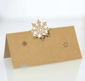 Macro detail of laser-cut snowflake design on brown kraft paper place card for Christmas