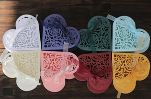 Macro detail of laser-cut heart candy boxes with rose patterns in 8 assorted colors