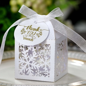 Laser-cut white snowflake gift box with translucent ribbon and golden thank you card
