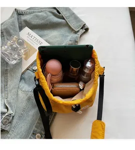 Interior view of yellow bucket bag showing spacious storage for tablet and umbrella