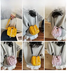 Detail view of nylon bucket bags with cat print and thick rope drawstring closure