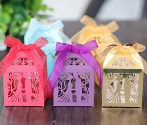 Detailed laser-cut candy boxes with ribbon bows for weddings in multiple vibrant colors