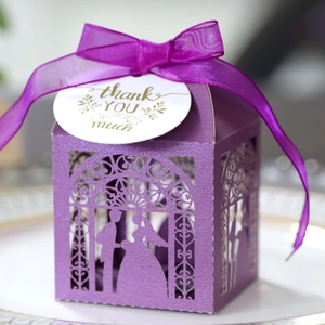 Detail of purple hollow wedding candy box with bow ribbon and thank you card
