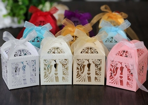 Macro shot of laser-cut heart candy boxes with ribbons for wedding favors