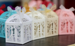 Laser cut wedding favor boxes with ribbon bow detail and intricate hollow out patterns