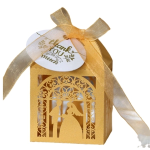 Gold hollow laser cut wedding candy box with couple silhouette and elegant ribbon