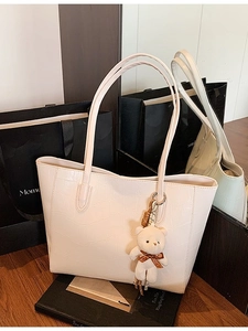 Minimalist creamy white crocodile embossed tote bag with cute plush bear pendant