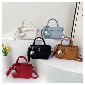 Litchi pattern leather mini bags in five colors with heart charms on display stands