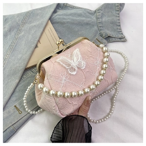 Detailed shot of pink lace embroidery purse with 3D butterflies and pearl handle