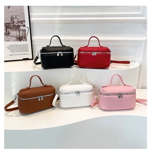 Close-up of five color options for mini square leather bags with silver zipper hardware