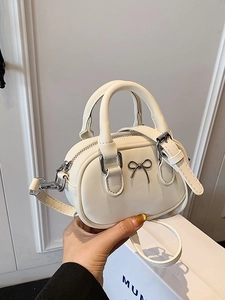 Mini cream white crossbody bag with silver bow detail and dual top handles