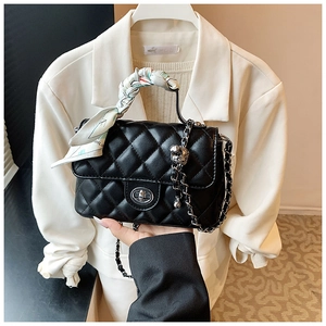 Close-up of black quilted PU leather crossbody bag with chain strap and decorative scarf