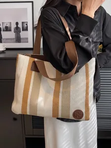 Large striped canvas tote bag with brown woven straps for casual commuting and daily use