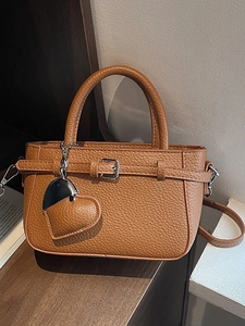 Red lychee pattern leather shoulder bag with heart charm and top handle strap