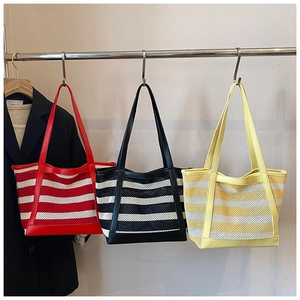 Detailed view of striped mesh tote bags with reinforced handles in red black and yellow