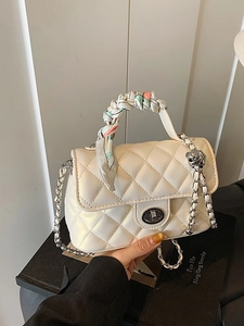 Quilted white leather crossbody bag with chain strap and decorative floral scarf handle