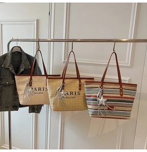 Straw tote bags with leather handles and Paris Milano print in stylish room setting