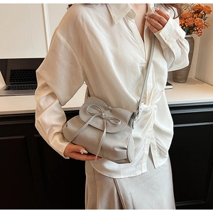 Detail der grauen Ballet-Beuteltasche mit Schleife aus weichem Leder und eleganter Textur